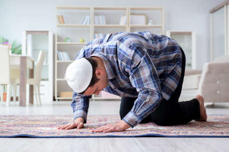 Muslim man praying at homeの写真素材