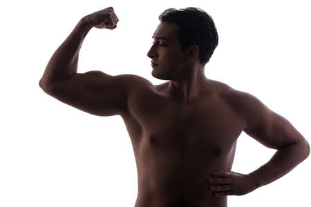 Handsome man flexing his muscles on whiteの写真素材