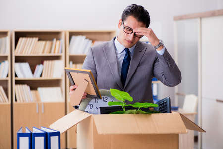 Man moving office with box and his belongingsの写真素材