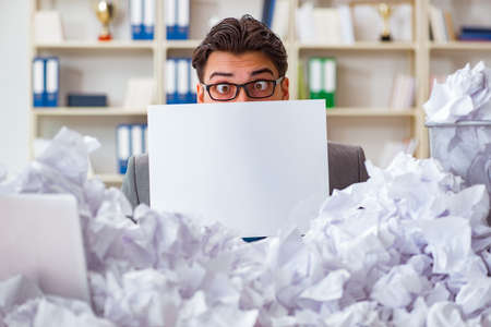 Businessman in paper recycling concept in office