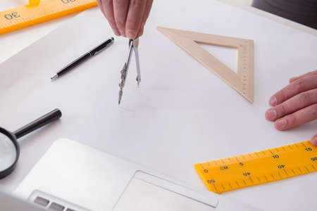 Male engineer working on drawings and blueprints