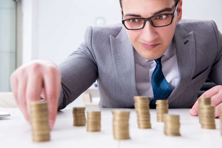 Businessman with golden coins in business growth concept