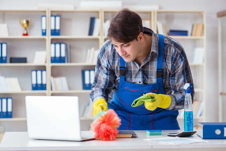 Male cleaner working in the office