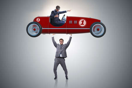 Businessman lifting sports car in power conceptの写真素材