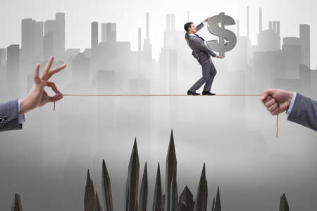 Businessman walking on tight ropeの写真素材