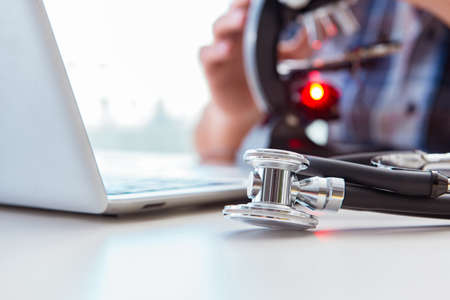 High precision engineering with man working with microscopeの写真素材