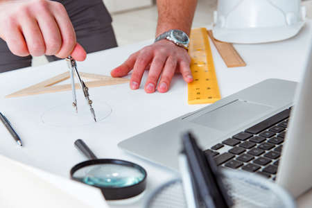 Male engineer working on drawings and blueprintsの写真素材