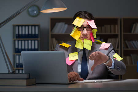 Businessman staying late to sort out prioritiesの写真素材