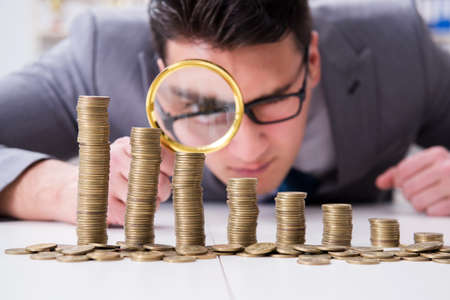 Businessman with golden coins in business growth conceptの写真素材