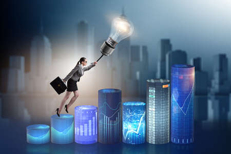 Businessman flying on lamp balloonの写真素材