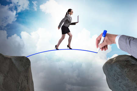 Hand drawing bridge under businesswomanの写真素材