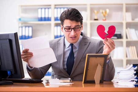 Businessman in saint valentine concept in officeの写真素材