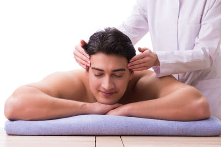 Handsome man in spa massage conceptの写真素材