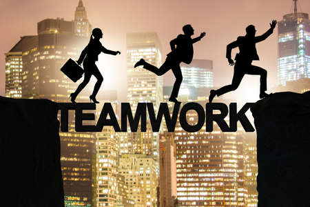 Teamwork concept with business people crossing bridgeの写真素材