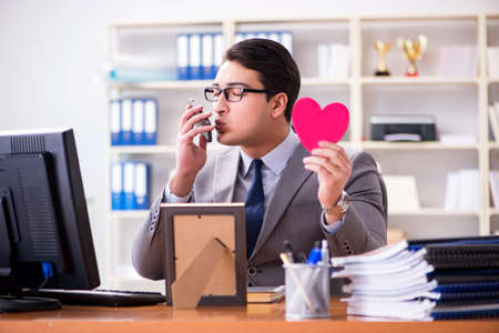 Businessman feeling love and loved in the officeの写真素材