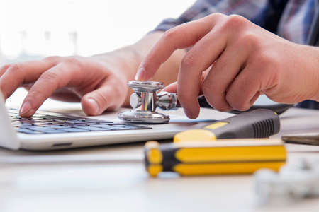 Computer repairman repairing computer laptopの写真素材