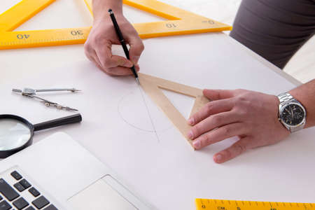 Male engineer working on drawings and blueprints
