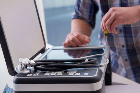 Repairman repairing broken color printer