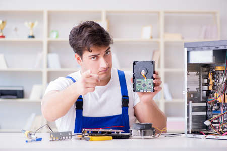 Computer repairman repairing desktop computerの写真素材