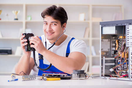 Computer repairman repairing desktop computerの写真素材