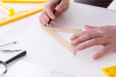 Male engineer working on drawings and blueprints