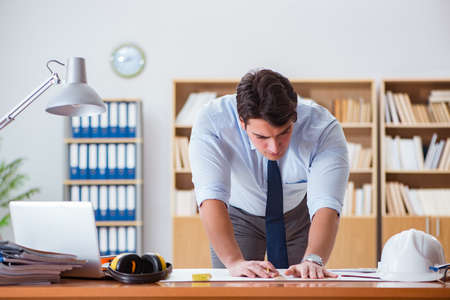 Engineer supervisor working on drawings in the office