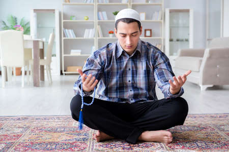 Muslim man praying at homeの写真素材