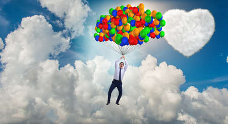 Man flying balloons in romantic concept