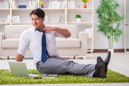 Businessman sitting on the floor in officeの写真素材