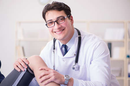 Man doctor taking care of sports injuryの写真素材