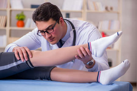 Man doctor taking care of sports injuryの写真素材