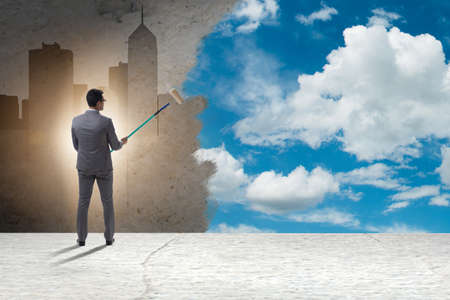 Businessman painting sky and clouds