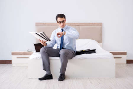 Businessman working in hotel roomの写真素材