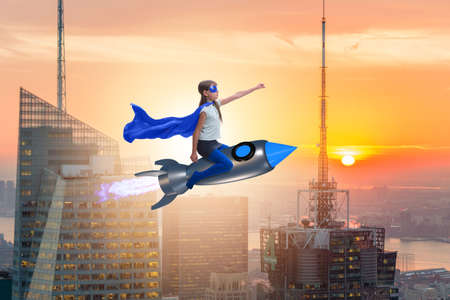 Little girl flying rocket in superhero conceptの写真素材