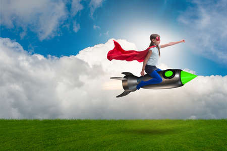 Little girl flying rocket in superhero conceptの写真素材