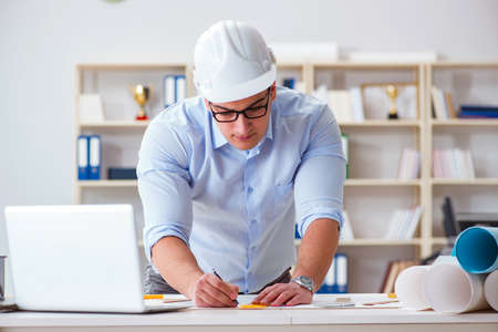 Male engineer working on drawings and blueprints