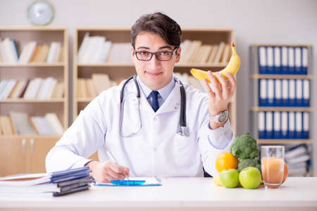 Scientist studying nutrition in various foodの写真素材