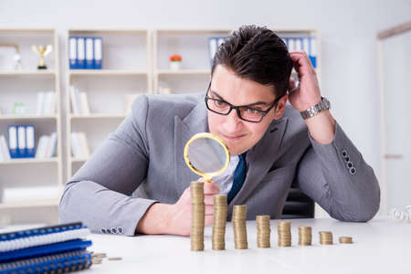 Businessman with golden coins in business growth conceptの写真素材