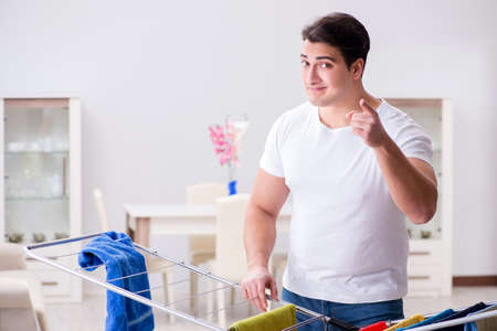 Man doing laundry at homeの写真素材