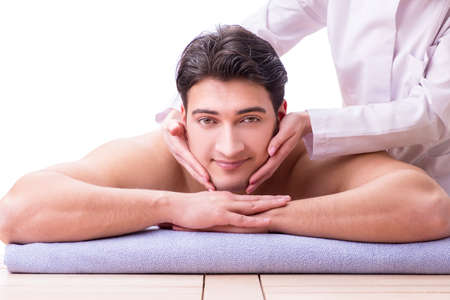 Handsome man in spa massage conceptの写真素材