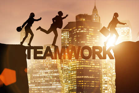 Teamwork concept with business people crossing bridgeの写真素材