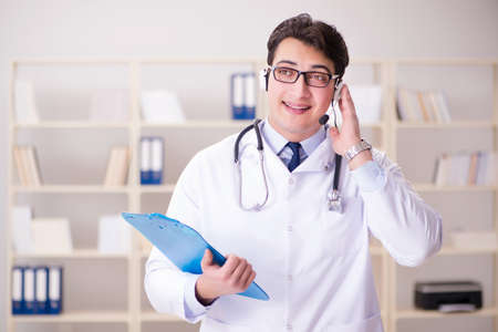 Young man doctor in medical conceptの写真素材