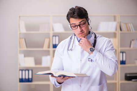 Young man doctor in medical conceptの写真素材