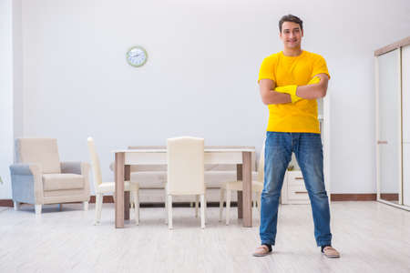 Young man doing chores at homeの写真素材