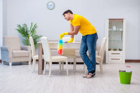 Young man doing chores at homeの写真素材