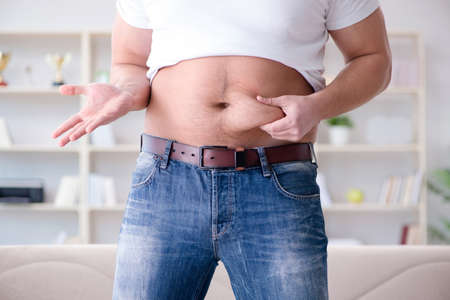Man suffering from extra weight in diet concept