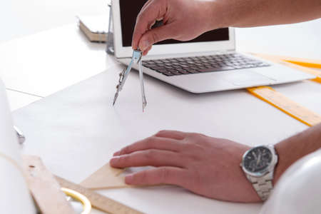 Male engineer working on drawings and blueprints