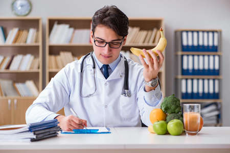 Scientist studying nutrition in various foodの写真素材