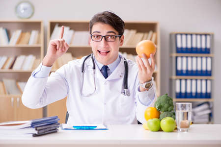 Scientist studying nutrition in various foodの写真素材