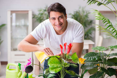 Young man in gardening concept at home